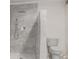Modern bathroom featuring a glass-enclosed shower with upscale showerhead and neutral colored tiling at 13201 N 24Th Ave, Phoenix, AZ 85029