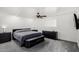 Cozy bedroom with neutral carpet, ceiling fan, and contemporary dark wood furniture at 13201 N 24Th Ave, Phoenix, AZ 85029
