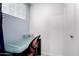 Office area with glass desk and task chair near window and door, with a white painted wall at 13201 N 24Th Ave, Phoenix, AZ 85029