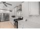 Updated kitchen features stainless steel appliances, white subway tile backsplash, and modern fixtures at 13201 N 24Th Ave, Phoenix, AZ 85029
