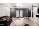 Bright living area featuring modern floors, ceiling fans, and doors to the backyard at 13201 N 24Th Ave, Phoenix, AZ 85029