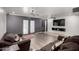 A stylish living room with wood floors, ceiling fans, and double doors to the yard at 13201 N 24Th Ave, Phoenix, AZ 85029