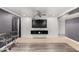 Contemporary living space with mounted TV and a mix of tile and plank flooring at 13201 N 24Th Ave, Phoenix, AZ 85029
