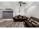 A modern living room with plank flooring and an adjacent dining area with modern lighting at 13201 N 24Th Ave, Phoenix, AZ 85029