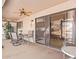 Enclosed back patio with seating, ceiling fan, and view to the backyard at 13718 W Gable Hill Dr, Sun City West, AZ 85375