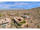 Panoramic aerial view of a sprawling desert property, showcasing pool, lush yard, and mountain views at 14675 E Paradise Dr, Fountain Hills, AZ 85268