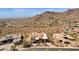 Stunning aerial view of desert home with mountain backdrop, beautiful landscaping, and tile roof at 14675 E Paradise Dr, Fountain Hills, AZ 85268