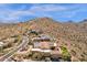 Aerial view of desert home with beautiful landscaping, solar panels, and majestic mountain views at 14675 E Paradise Dr, Fountain Hills, AZ 85268