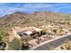 Aerial view of desert estate boasts gorgeous roof, desert landscaping, and nearby mountain views at 14675 E Paradise Dr, Fountain Hills, AZ 85268