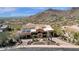 Aerial view of a gorgeous estate featuring a terra cotta roof, desert landscaping, and mountain views at 14675 E Paradise Dr, Fountain Hills, AZ 85268