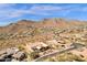 Expansive aerial view of a desert property with red tile roof, solar panels, and mountain backdrop at 14675 E Paradise Dr, Fountain Hills, AZ 85268