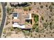 An aerial view of a large home with a tile roof, solar panels, a green yard, and desert landscaping at 14675 E Paradise Dr, Fountain Hills, AZ 85268