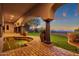 Backyard features an outdoor spa, brick flooring, mature trees, and mountain views at 14675 E Paradise Dr, Fountain Hills, AZ 85268