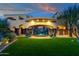Lush backyard featuring a flowing waterfall feature, manicured lawn and desert landscaping at 14675 E Paradise Dr, Fountain Hills, AZ 85268