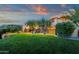 Backyard features sprawling green lawn, mature trees, and exterior with architectural design at 14675 E Paradise Dr, Fountain Hills, AZ 85268