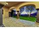 Covered patio featuring manicured lawn with mountain views and illuminated trees offering a serene escape at 14675 E Paradise Dr, Fountain Hills, AZ 85268
