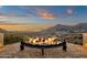 Enjoy the desert views while sitting around the fireplace on this home's large brick balcony at 14675 E Paradise Dr, Fountain Hills, AZ 85268