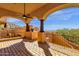 Covered balcony featuring a ceiling fan, brick flooring, and scenic views of the surrounding landscape at 14675 E Paradise Dr, Fountain Hills, AZ 85268