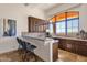 Stylish wet bar with cabinetry, tile backsplash, bar stool seating, and a view at 14675 E Paradise Dr, Fountain Hills, AZ 85268