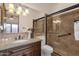 Bathroom featuring a granite counter, tile backsplash, toilet, and tub with glass door at 14675 E Paradise Dr, Fountain Hills, AZ 85268