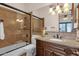 Bathroom featuring a granite counter, tile backsplash, toilet, and tub with glass door at 14675 E Paradise Dr, Fountain Hills, AZ 85268