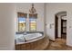 Bright bathroom with tub near window with chandelier lighting and natural light at 14675 E Paradise Dr, Fountain Hills, AZ 85268