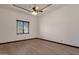 Bright bedroom features a ceiling fan, wood floors, and window that provide natural light at 14675 E Paradise Dr, Fountain Hills, AZ 85268