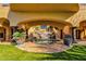 Outdoor courtyard with a serene pool, waterfall feature, and lush landscaping at 14675 E Paradise Dr, Fountain Hills, AZ 85268