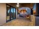 Covered patio with large windows, ceiling fan, brick flooring, and views of the pool and mountains at 14675 E Paradise Dr, Fountain Hills, AZ 85268