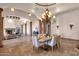 Bright dining room featuring a stone floor, high ceilings, decorative columns, and an elegant chandelier at 14675 E Paradise Dr, Fountain Hills, AZ 85268