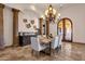 Dining area with tiled floors, decorative chandelier, exposed support columns, and seating for six at 14675 E Paradise Dr, Fountain Hills, AZ 85268