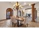 Dining area with tiled floors, decorative chandelier, exposed support columns, and seating for six at 14675 E Paradise Dr, Fountain Hills, AZ 85268