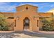 Elegant entry gate with an arched design, decorative ironwork, sconces and lush desert landscaping at 14675 E Paradise Dr, Fountain Hills, AZ 85268