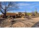 Spacious desert home featuring mature landscaping and a private driveway, with a view of the front entrance at 14675 E Paradise Dr, Fountain Hills, AZ 85268