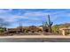 Beautiful desert home with neutral stucco, desert landscaping, and mountain views in the distance at 14675 E Paradise Dr, Fountain Hills, AZ 85268
