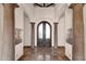 Elegant foyer with stone columns, tiled floor, and double doors with decorative sidelight features at 14675 E Paradise Dr, Fountain Hills, AZ 85268