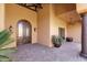 Grand covered entrance featuring stone column support, decorative lights, and a lush potted plant at 14675 E Paradise Dr, Fountain Hills, AZ 85268