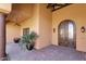 Covered front entrance with a wood beam, double doors, a column, and lush potted plant at 14675 E Paradise Dr, Fountain Hills, AZ 85268