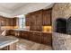 Well-appointed kitchen with custom cabinetry, granite countertops, a pizza oven, and natural lighting at 14675 E Paradise Dr, Fountain Hills, AZ 85268
