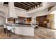 Open concept kitchen with a stone pizza oven, custom wood cabinetry, granite countertops, and stylish seating at 14675 E Paradise Dr, Fountain Hills, AZ 85268