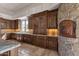 Well-appointed kitchen with custom cabinetry, granite countertops, a pizza oven, and natural lighting at 14675 E Paradise Dr, Fountain Hills, AZ 85268