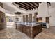 Open kitchen featuring a large island with granite countertops, stone pizza oven, and decorative wood beams at 14675 E Paradise Dr, Fountain Hills, AZ 85268