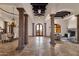 Expansive living room featuring columns, travertine tile flooring, and multiple seating areas at 14675 E Paradise Dr, Fountain Hills, AZ 85268