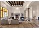 Living room featuring columns, travertine tile flooring, coffered ceilings, and a fireplace at 14675 E Paradise Dr, Fountain Hills, AZ 85268