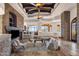 Comfortable living room features a stone fireplace, beamed ceilings, and tile floors at 14675 E Paradise Dr, Fountain Hills, AZ 85268