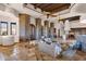 Elegant living room with stone pillars, beamed ceilings, tile floors, and comfortable seating at 14675 E Paradise Dr, Fountain Hills, AZ 85268