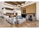 Open living room showcases stone fireplace, tile floors, beamed ceilings, and an adjacent kitchen at 14675 E Paradise Dr, Fountain Hills, AZ 85268