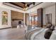 Spacious main bedroom boasts a stone fireplace, wood floors, decorative ceilings, and patio access at 14675 E Paradise Dr, Fountain Hills, AZ 85268
