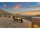 Desert property with a fire feature and sunset views from a brick patio and surrounding hills at 14675 E Paradise Dr, Fountain Hills, AZ 85268