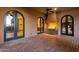 Outdoor kitchen featuring stainless steel grill, arched doorways, and brick flooring for elegant al fresco dining at 14675 E Paradise Dr, Fountain Hills, AZ 85268